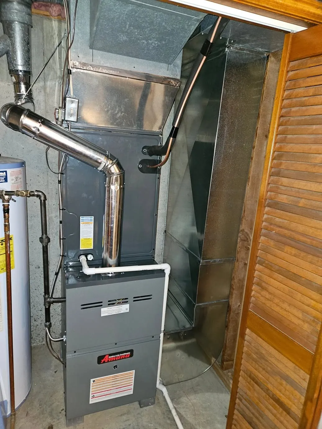 Gas furnace with flue pipe installed in a utility closet